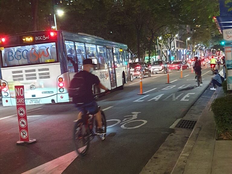 Protected Bike Lanes Turn Focus to Safer Junction Designs cyclists riding in a protected bike lane